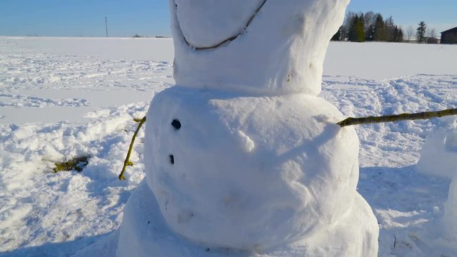 The snowman that looks like Olaf from a movie during a winter season in the village