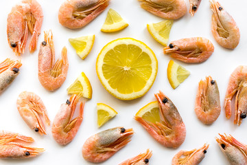 Meal background - shrimps with lemon. Creative pattern. Flat lay