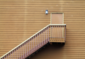 Wooden Stairs Leading to a Door in the middle of a Wall