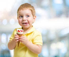 Happy kid eating icecream on blurred background