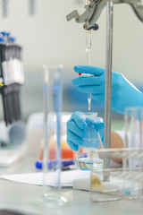 The woman who’s the scientist is demonstrate the titration tec