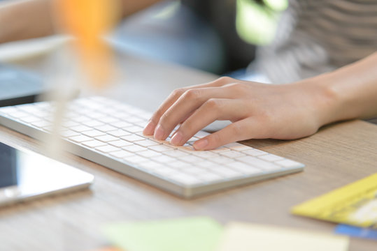 Close-up Of Female Left-hand Typing On Bluetooth Keyboard