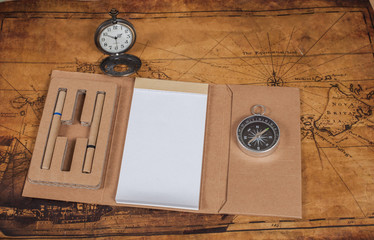 Compass with note book on old map vintage process style
