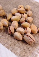 Pistachio nuts on white wooden table, healthy eating