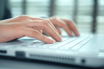 Obraz na płótnie Canvas business woman hand typing on laptop keyboard