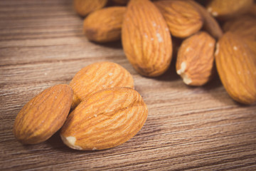 Vintage photo, Heap of almonds on wooden background