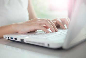 business woman hand typing on laptop keyboard