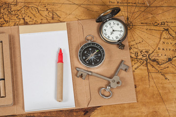 Compass with note book on old map vintage process style