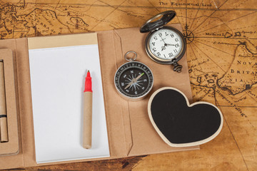 Compass with note book on old map vintage process style
