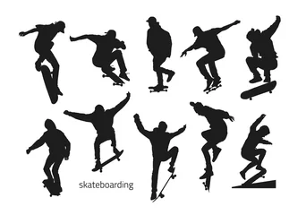 Fotobehang black silhouettes of skateboarders on a white background © shurkin_son