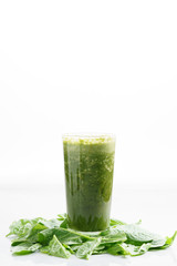 glass of fresh green spinach and kale healthy smoothie