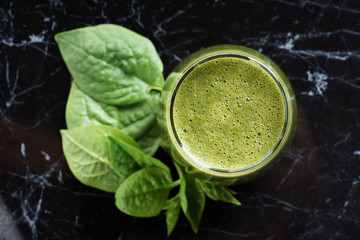 glass of fresh green spinach and kale healthy smoothie
