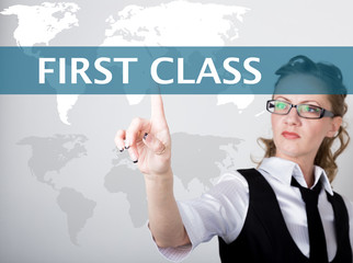 first class written on a virtual screen. Internet technologies in business and tourism. woman in business suit and tie, presses a finger on a virtual screen
