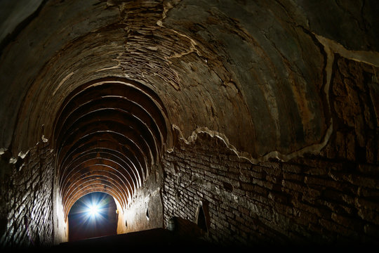 tunnel background and business concept. tunnel with old brick. the end of tunnel and concept business successfully. mystery tunnel or mystery way. tunnel damaged and waited for repair.
