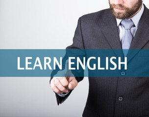 technology, internet and networking concept - Businessman presses learn english button on virtual screens. Internet technologies in business