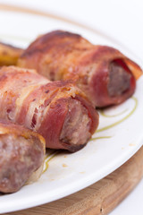 Kebabs rolled in bacon served on a plate