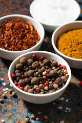 assortment of pepper, different spices and sea salt in bowl 