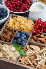 breakfast cereal and other ingredients in a wooden box, vertical
