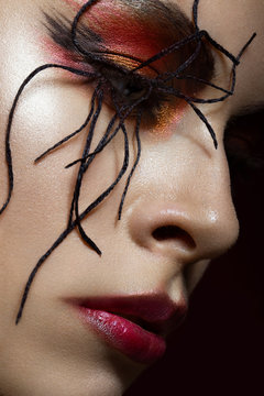 woman in the image of spider with creative art makeup. beauty face. Close up