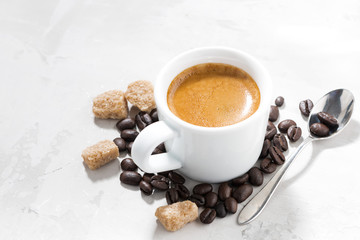 cup of espresso and sugar on a white table