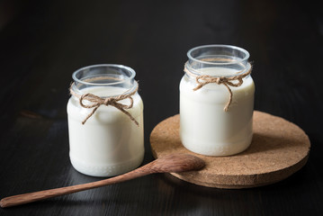 natural yogurt in a jar on the dark background