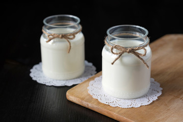 natural yogurt in a jar on the dark background