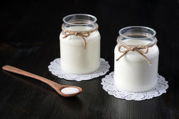 natural yogurt in a jar on the dark background