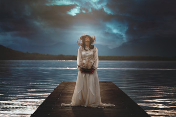 Woman alone on surreal lake pier