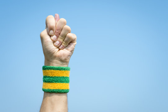 Brazilian good luck hand sign known as the figa with the thumb poking between fingers of a fist