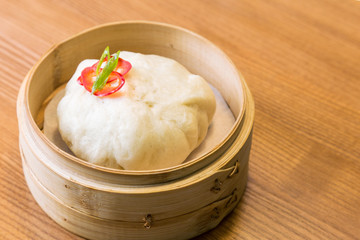 Asian steam bun in a bamboo steamer