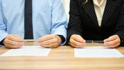 Woman and man are reading agreement on meeting