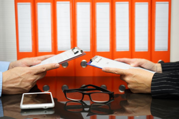 business partners are reading contract with documentation in bac