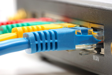 ethernet cable plugged into network router - obrazy, fototapety, plakaty