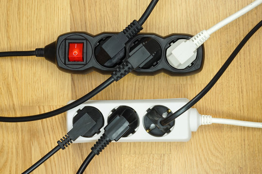 Many electrical cords connected to a  power strip