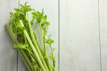 Fresh green celery on wooden white background