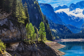 The snow-covered peaks in the Alps with a beautiful green mounta