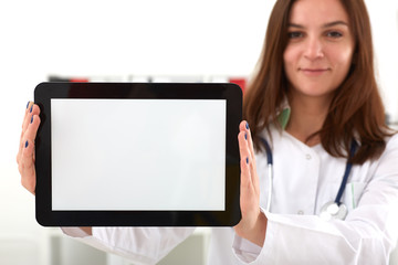 Female medicine doctor holding tablet with white screen in hands