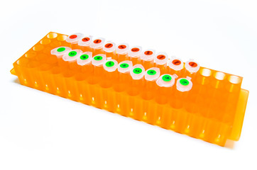 1.5 ml eppendorf tube or micro centrifuge tube in orange rack on white background