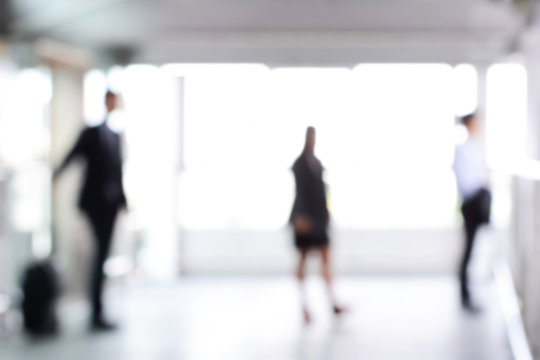 Blurred business people standing in building hall
