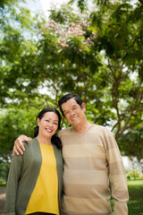 Obraz premium Portrait of happy senior Vietnamese couple standing outdoors