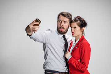 Two colleagues friends taking selfie with telephone camera