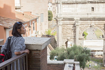 Woman looks at the Arch of Septimius Severus