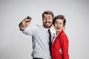 Two colleagues friends taking selfie with telephone camera