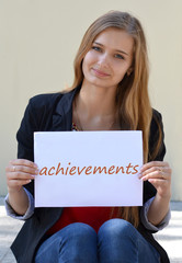 Beautiful,cheerful,smiling,light-haired girl with an inscription 