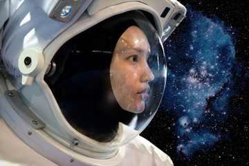 Fototapeta premium Astronaut woman on space mission with stars on the background