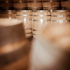 Winemaker barrels moving up or down by rolling on ground