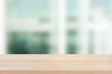 Wood table top on blurred white background of building hallway