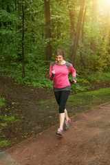 Runner woman jogging in summer forest.
