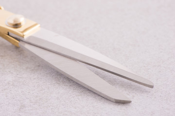 Close-up of scissors on a stone table. Equipment used for sewing or tailoring work.