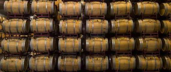 Wine barrels stacked in cellar, Bordeaux Vineyard